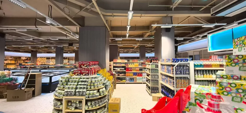 retail shelf lighting in supermarket using linear track lighting for product display and aisle illumination